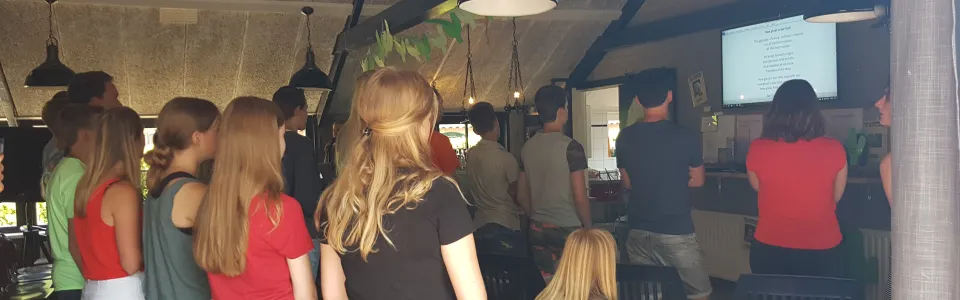 Deelnemers staan te kijken in de zaal